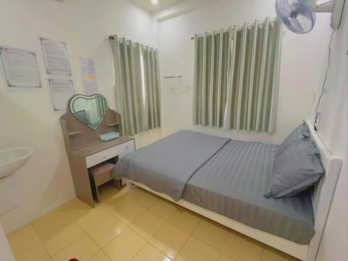 a bedroom with a bed and a sink and a mirror at Lucky 2 Hotel in Trà Vinh