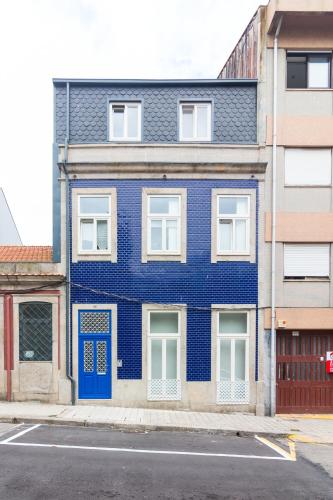 a blue building with a blue door on a street at ON Apartments - Lapa Deluxe in Porto