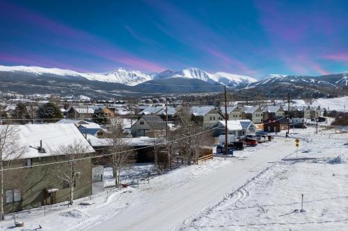 a town covered in snow with mountains in the background at Luxury Modern Tiny Home in Downtown Fraser in Fraser