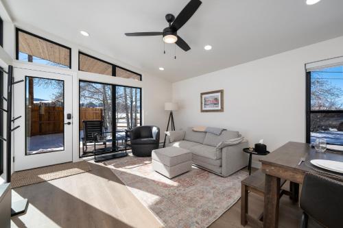 a living room with a couch and a table at Luxury Modern Tiny Home in Downtown Fraser in Fraser