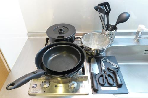a frying pan sitting on top of a stove at Domire Setagaya by Tranova in Tokyo