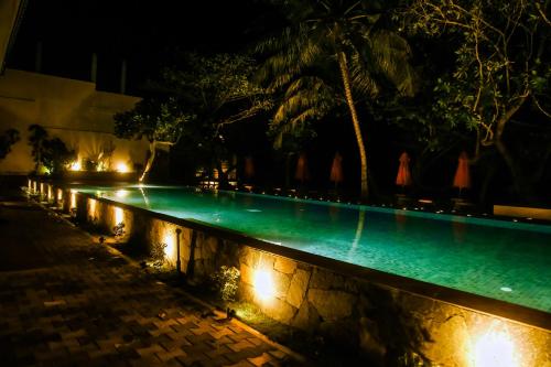 a swimming pool at night with lights on it at Surf Sea Breeze in Mirissa
