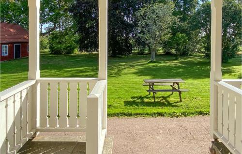 a porch with a picnic table in the grass at 6 Bedroom Gorgeous Home In Tranås in Tranås