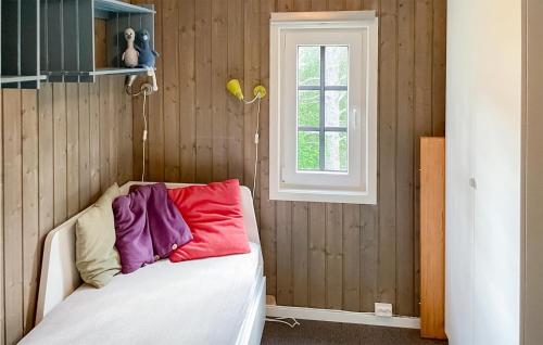 a bedroom with a bed with colorful pillows on it at Beautiful Home In Tingvatn in Tingvatn