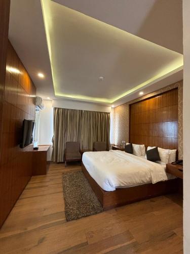 a hotel room with a bed and a television at Palette 823 Hotel Ichchha in Simara