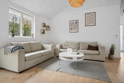 a living room with two couches and a coffee table at Sommerhus i Arrild Ferieby nær Vesterhavet in Arrild