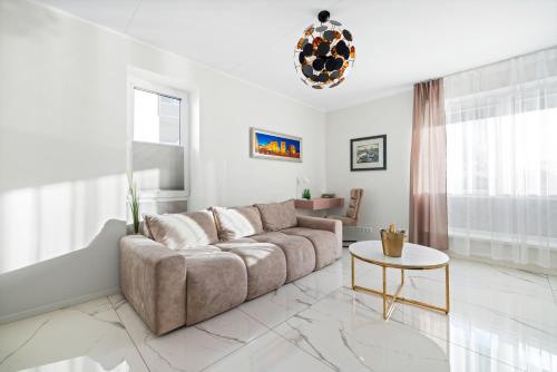 a living room with a couch and a table at F-Apartments - River view, Contactless in Tartu