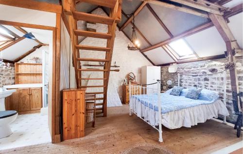 a bedroom with a bed and a ladder in a room at 2 Bedroom Nice Home In Le Ferré in Le Ferré