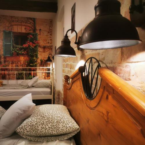 a room with a bed and a lamp and a bench at Kúria Apartman Private Wellness in Budapest