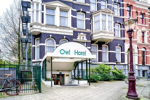 a building with a hotel sign in front of it at Owl Hotel in Amsterdam