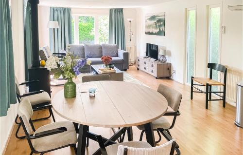a living room with a table and a couch at Lovely StaCaravan In Putten With Wifi in Putten