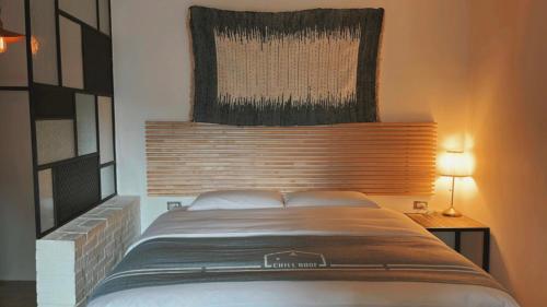 a bedroom with a large bed with a head board at Chill Roof Hotel in Taipei