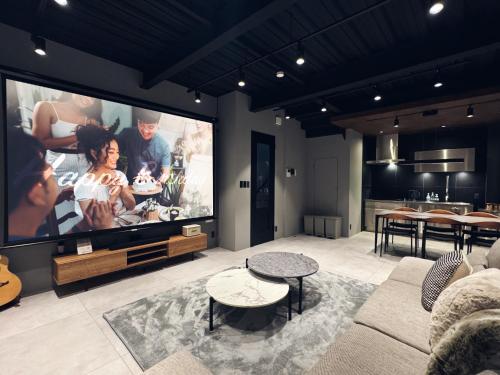 a living room with a large flat screen tv at TABISAI HOTEL Swell 天神 in Fukuoka
