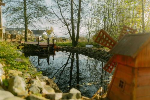 a body of water with a house in the background at Romantic Getaway for 2 with Wellness / Bohemian Homes in Studánka