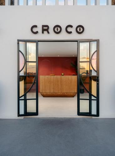 a store front with a bed in the window at Croco Mykonos in Tourlos