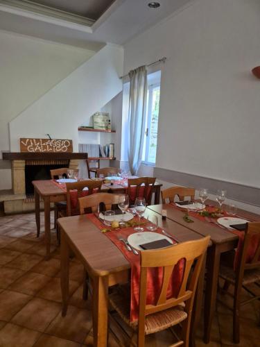a dining room with wooden tables and chairs and a fireplace at Locanda Rocchetta-Premilcuore in Premilcuore