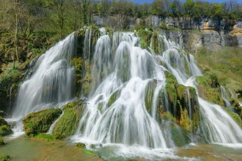 a waterfall on the side of a mountain at Gîte de la croix du Dan in Poligny