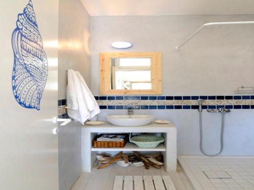 a bathroom with a sink and a mirror at Your seaside luxury retreat in Greece with private beach in Korissia