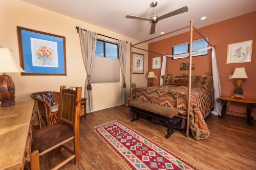 a bedroom with a canopy bed and a table at A Sunset Chateau in Sedona