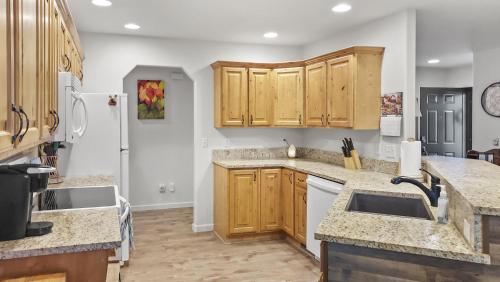 a kitchen with wooden cabinets and white appliances at Hermosa Haven home in Montrose