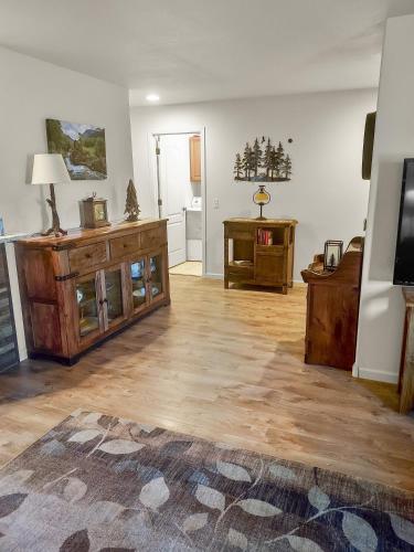 a living room with wooden floors and a flat screen tv at Hermosa Haven home in Montrose