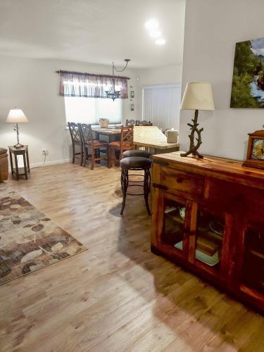 a living room with a table and a dining room at Hermosa Haven home in Montrose