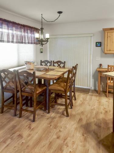 a dining room with a wooden table and chairs at Hermosa Haven home in Montrose