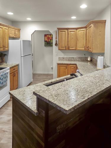 a kitchen with wooden cabinets and a granite counter top at Hermosa Haven home in Montrose