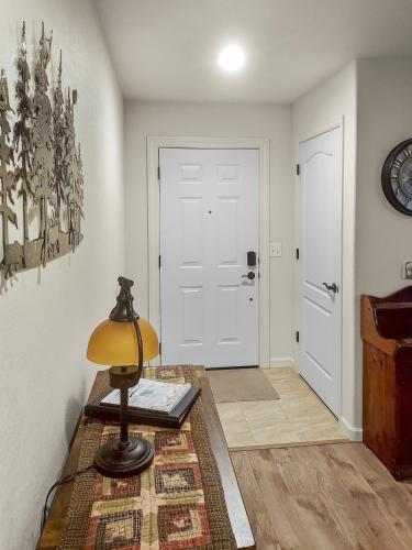 a lamp on a table in a room with a door at Hermosa Haven home in Montrose