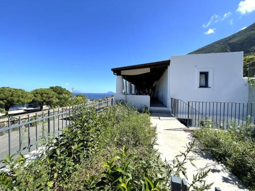 a white building with a fence around it at Case a Malfa - Alba & Rosina, Isola Salina in Malfa