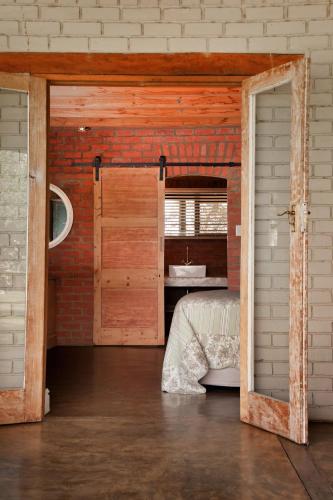 a room with a bed in a brick wall at Dalmore Guest Farm in Bergville