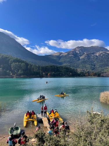 a group of people on rafts on a lake at The Lake house Feneos in Archaia Feneos