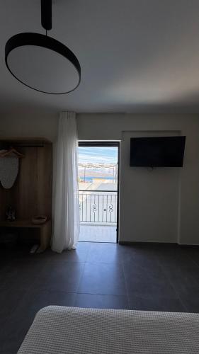 a bedroom with a bed and a large window at 5th Continent in Nikiana