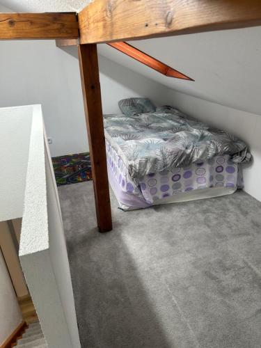 a small bed under a shelf in a room at Ferienhaus im Schwarzwald in Pforzheim