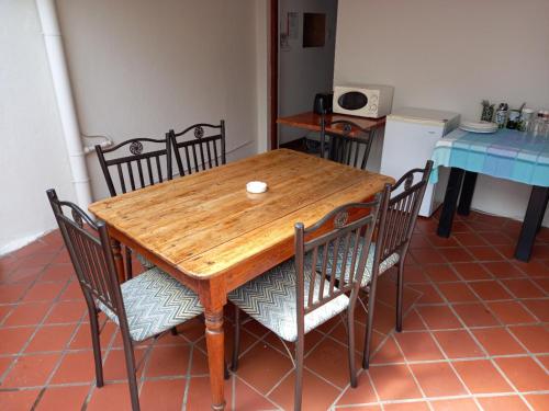 a wooden table and chairs in a kitchen at 137 High Street Guest House in Grahamstown