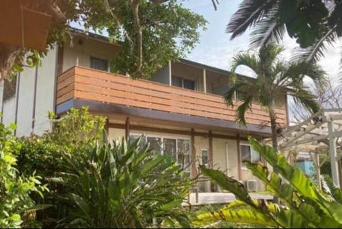 a building with a palm tree in front of it at Beach and Mountain in Ishigaki Island
