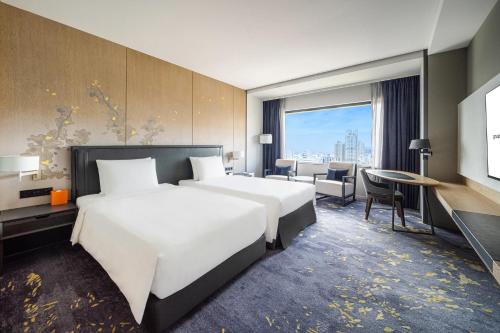 Una cama o camas en una habitación de Hotel Nikko Kaohsiung