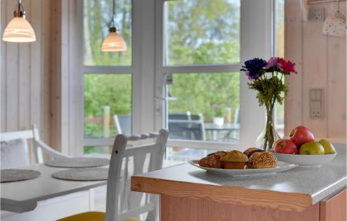a table with a bowl of fruit and a plate of food at Lovely Home In Haderslev With Wifi in Haderslev