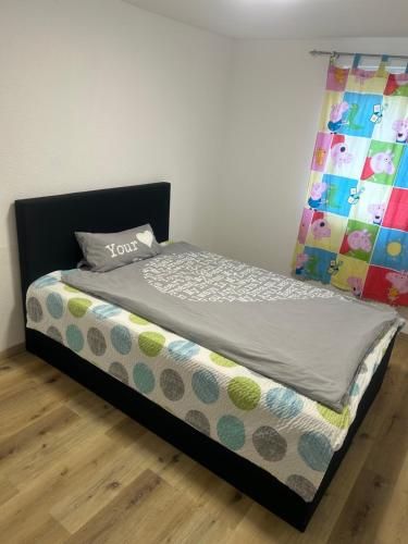 a bedroom with a bed with a colorful quilt at Ferienhaus im Schwarzwald in Pforzheim