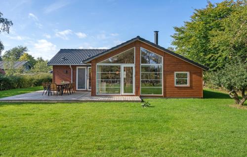 a small house with a deck and a patio at Lovely Home In Skælskør With Kitchen in Skælskør