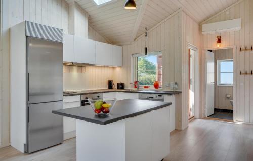 a kitchen with white cabinets and a stainless steel refrigerator at Lovely Home In Skælskør With Kitchen in Skælskør