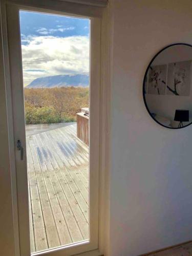 a door with a window with a view of a deck at Prime Location-Golden Circle 3 Bedrooms in Selfoss