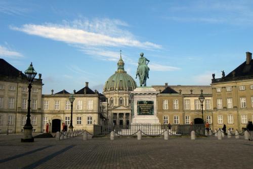 a large building with a statue in front of it at Beautiful Apartments on Strøget in Copenhagen City Center in Copenhagen