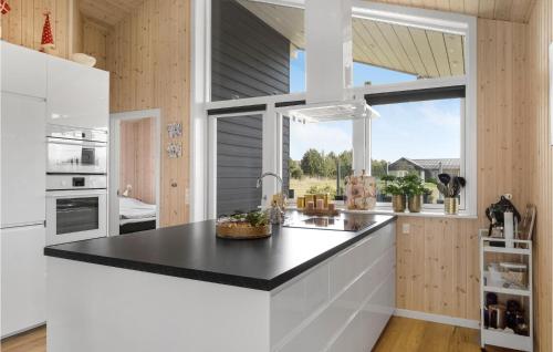 a kitchen with a black counter top and a window at Stunning Home In Væggerløse With Wifi in Marielyst