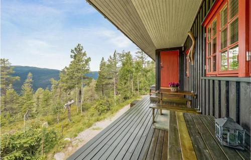 a house with a deck with a view of the mountains at 3 Bedroom Amazing Home In Eggedal in Eggedal