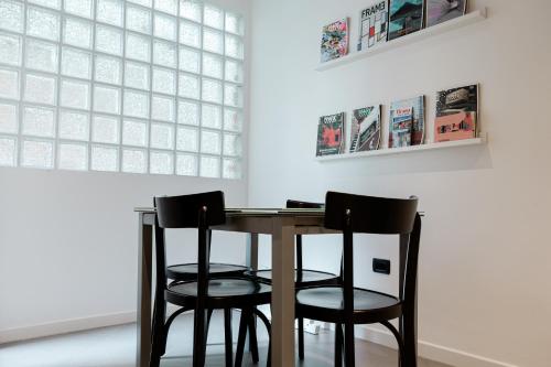 a table and two chairs in a room with a window at Boutique Hotel Whisky in Tirana
