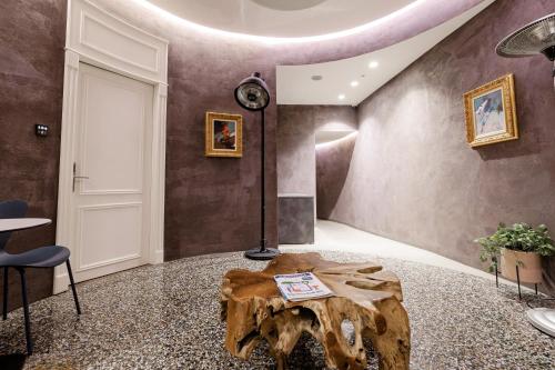 a room with a tree stump coffee table in the middle at Boutique Hotel Whisky in Tirana