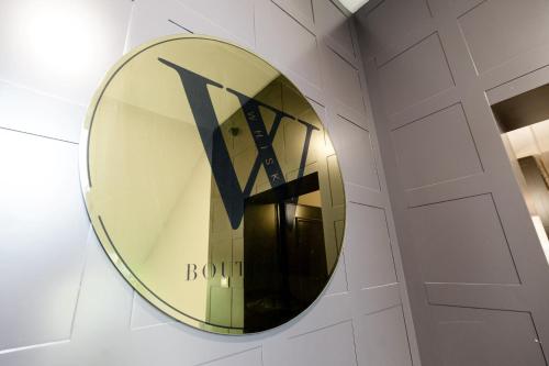 a mirror on a wall with the letter k on it at Boutique Hotel Whisky in Tirana
