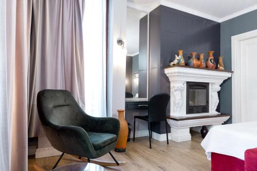 a bedroom with a bed and a chair and a desk at Boutique Hotel Whisky in Tirana
