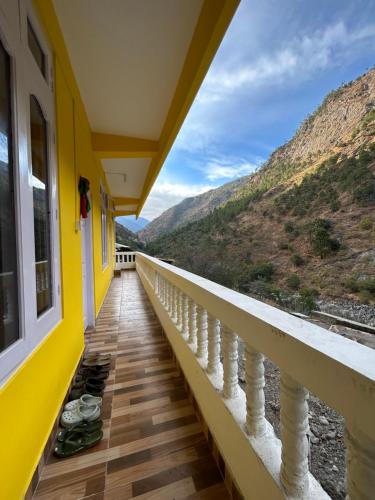 a balcony with a view of the mountains at Kalden Homestay in Dirang Dzong